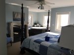 Master bedroom with a king bed and jetted 2 person tub overlooking Lake Michigan
